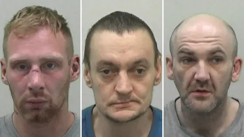 Mugshots of the three. Ellison has a short ginger beard and short fair hair with a very red complexion and large cut across the bridge of his nose. Davie has short greasy black hair, uneven eyes a wonky mouth and waxy yellow skin. Quinn is blad with stubble and a vacant expression on his face.