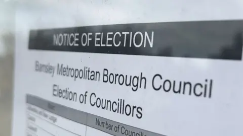 BBC/James Vincent A close up image of an election notice outside Barnsley Town Hall