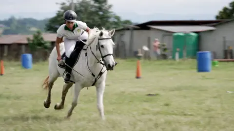 Makhosazana Dlomo on her horse while tent pegging