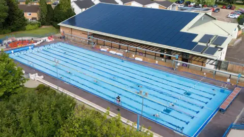 People swim at Banbury Lido at Woodgreen Leisure Centre in Oxfordshire.