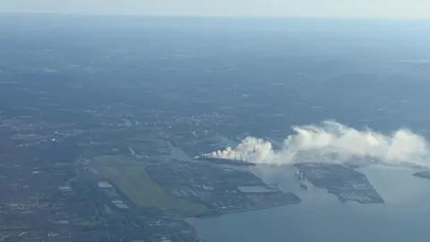 An aerial view above Belfast where smoke could be seen rising from a point above the harbour.