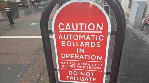 A sign saying automatic bollards are in operation