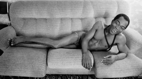 Getty Images Fela Kuti lying connected  a sofa successful  Paris successful  1986