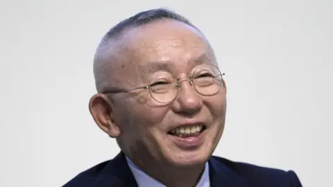 Getty Images Tadashi Yanai, chairman and chief executive officer of Fast Retailing Co., reacts during a news conference in Tokyo, Japan, on Thursday, Oct. 10, 2024. 