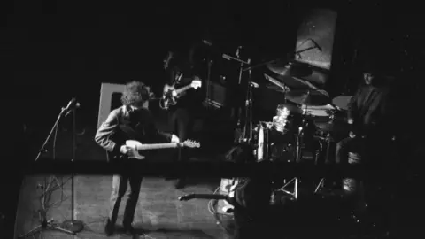 Alan Corbett Dylan and his band on stage at Manchester in 1966 in a mono photograph