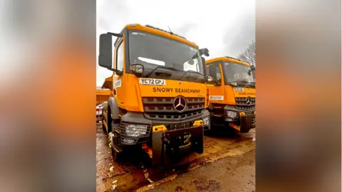 Oxfordshire County Council A close-up of a yellow gritter named Snowy Beauchamp, in honour of the late Oxford United football player Joey Beauchamp.