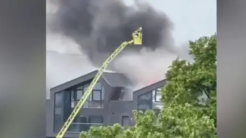 Smoke seen pouring from the block of flats b