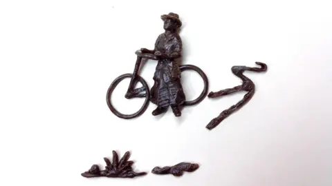 Jill Watson A bronze design of Isabel Cowe and her bicycle