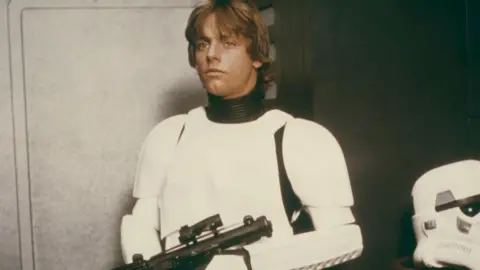 Getty Images Mark Hamill as Luke Skywalker disguised as a storm trooper in white body armour in a scene from Star Wars: Episode IV - A New Hope.