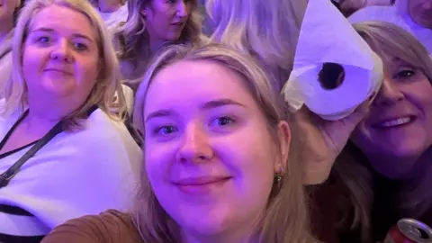 Abbie Foord Abbie Foord surrounded by her friends in the pantomime crowd.