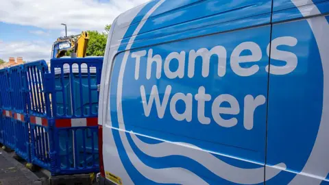 A Thames Water utility van parked on a London street next to construction work