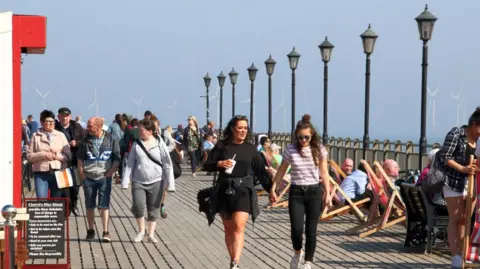 Getty Images People walking along Skegness pier