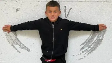 FAMILY HANDOUT William Brown wearing black trousers and a black jumper