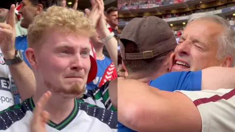 Men in football shirts hugging