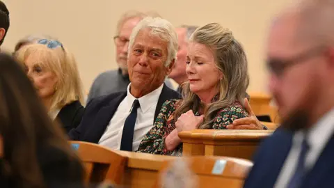 Getty Images Attorney Larry Stein, left, and actress Melissa Gilbert, wife of director and actor Timothy Busfield, react after a judge granted Busfield a pre-trial release during a hearing in the Second District Judicial Court at the Bernalillo County Courthouse on 20 January 2026 in Albuquerque, New Mexico.