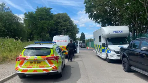 Police cars on a road.