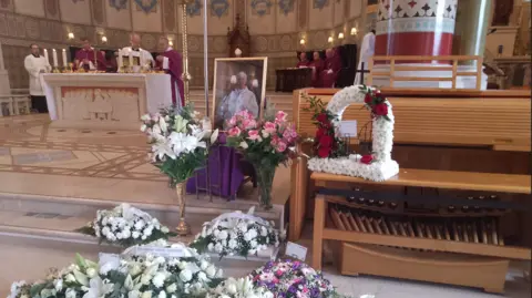 BBC Flowers were left during the funeral of Archbishop Noel Treanor at St Peter's Cathedral in Belfast on August 20, 2024