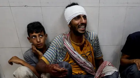 Reuters A man reacts at Nasser hospital in Khan Younis following a reported Israeli air strike on a camp for displaced people, in the southern Gaza Strip (9 July 2024)