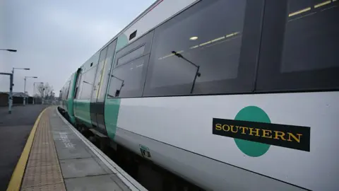 A Southern rail train stationed at a platform.