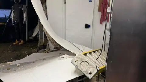 Ted Docherty A wall has collapsed with rubble and a ladder on the floor.