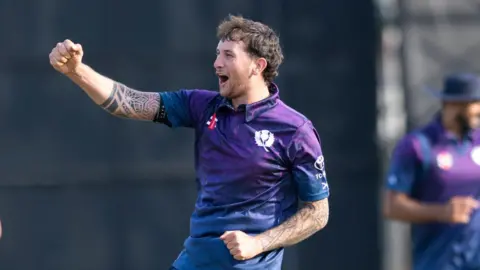Lyle Robertson celebrates taking a wicket