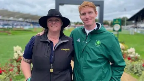 BBC Daniel Coyle dressed in Team Ireland uniform pictured with Legacy owner Ariel Grange, dressed in a black gilet jacket and black hat