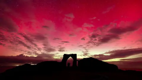 MATTHEW MUTTOCK The Silhouette of Gronez Castle in the red Northern Lights
