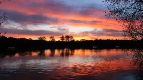 Peterborough Walks Blood-orange colour sky with its reflection in the water.