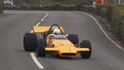 Denise Moore Dave Roberts in his McLaren M18 driving on the course