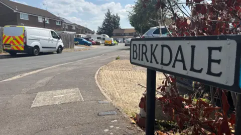 A general view of Birkdale in Bracknell, a residential street, with its street sign close up on the right side of the picture.