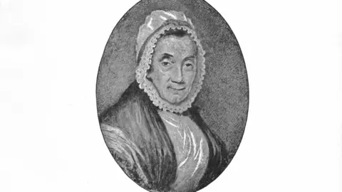 English Heritage A grey drawing of Bridget Atkinson in pencil. The drawing has an oval border and shows her looking straight ahead with a bonnet that frames her face.