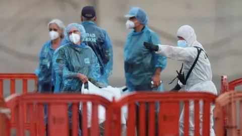 US passengers from the MV Hondius cruise ship are instructed by authorities after disembarking the vessel in Tenerife, Spain. Photo: 10 May 2026
