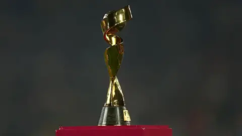 Reuters The picture shows the FIFA Women's World Cup at the final in of the 2023 tournament/ The trophy is gold with swirls going round a ball 