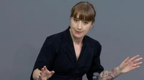 Getty pictures of a young woman talking in a lecture in Bondstag, German Parliament