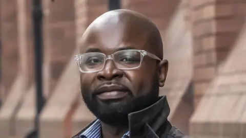 PA Felix Ngole, 46,