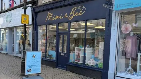 Mimi and Bee shop front is painted dark blue with gold sign writing