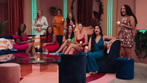 Netflix A group of women smiling in a candid picture from the Love is Blind set