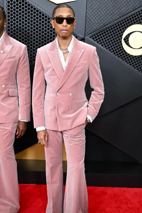 Getty Images Pharrell Williams in a pink suit