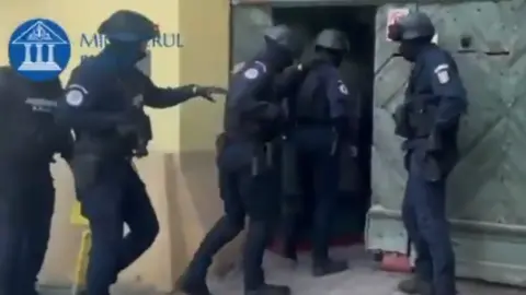 Romanian police officer who enters a building in Romania