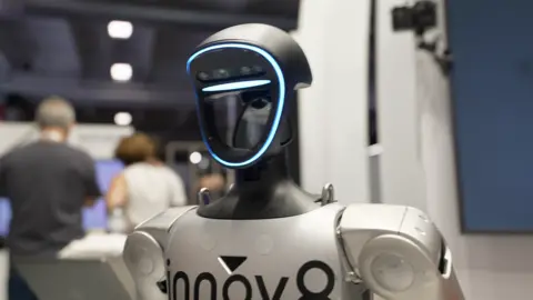 Close up of a humanoid robot with a black head with a blue light around it