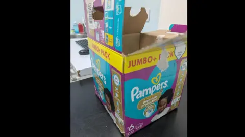 RSPCA Canterbury A bright-coloured Pampers nappy box placed on top of a table.
