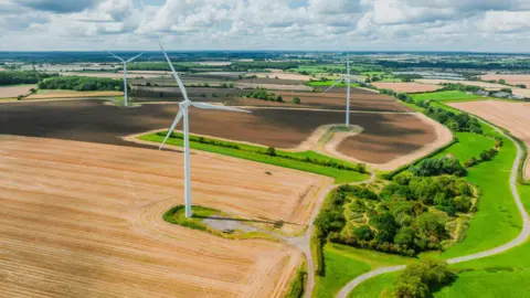 Getty Images Wind turbines connected  farmland