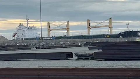 Andrew Turner/BBC The MV Ruby ship docked in Great Yarmouth. The large cargo ship sits next to a docking station.