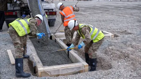 HELP Appeal Construction work on Gigha helipad - workers laying cement