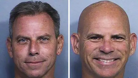 Mug shots of two men smiling, one with black greying hair and another bald man smiling