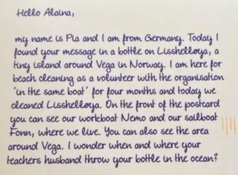  "My name is Pia and I am from Germany. Today I found your message in a bottle on Lisshelløya, a tiny island around Vega in Norway. I am here for beach cleaning as a volunteer with the organisation 'In the same boat' for four months and today we cleaned Lisshelløya. On the front of the postcard you can see our workboat Nemo and our sailboat Fonn, where we live. You can also see the area around Vega. I wonder when and where your teacher's husband threw your bottle in the ocean?"