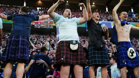 PA Scotland fans at Cologne Stadium celebrate