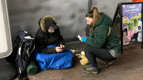 Rich and Harriet are on their mobile phones arranging an appointment 