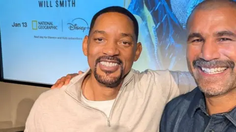 Richard Parks Will Smith and Richard Parks standing next to each other with their arms wrapped around each other