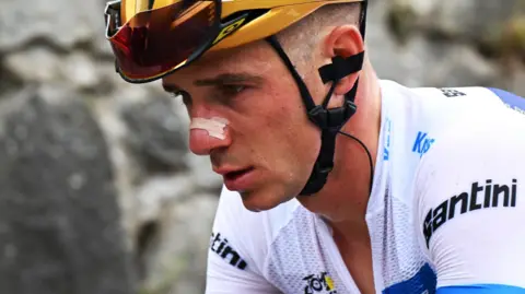 Remco Evenepoel in action wearing the young rider's white jersey at the 2025 Tour de France